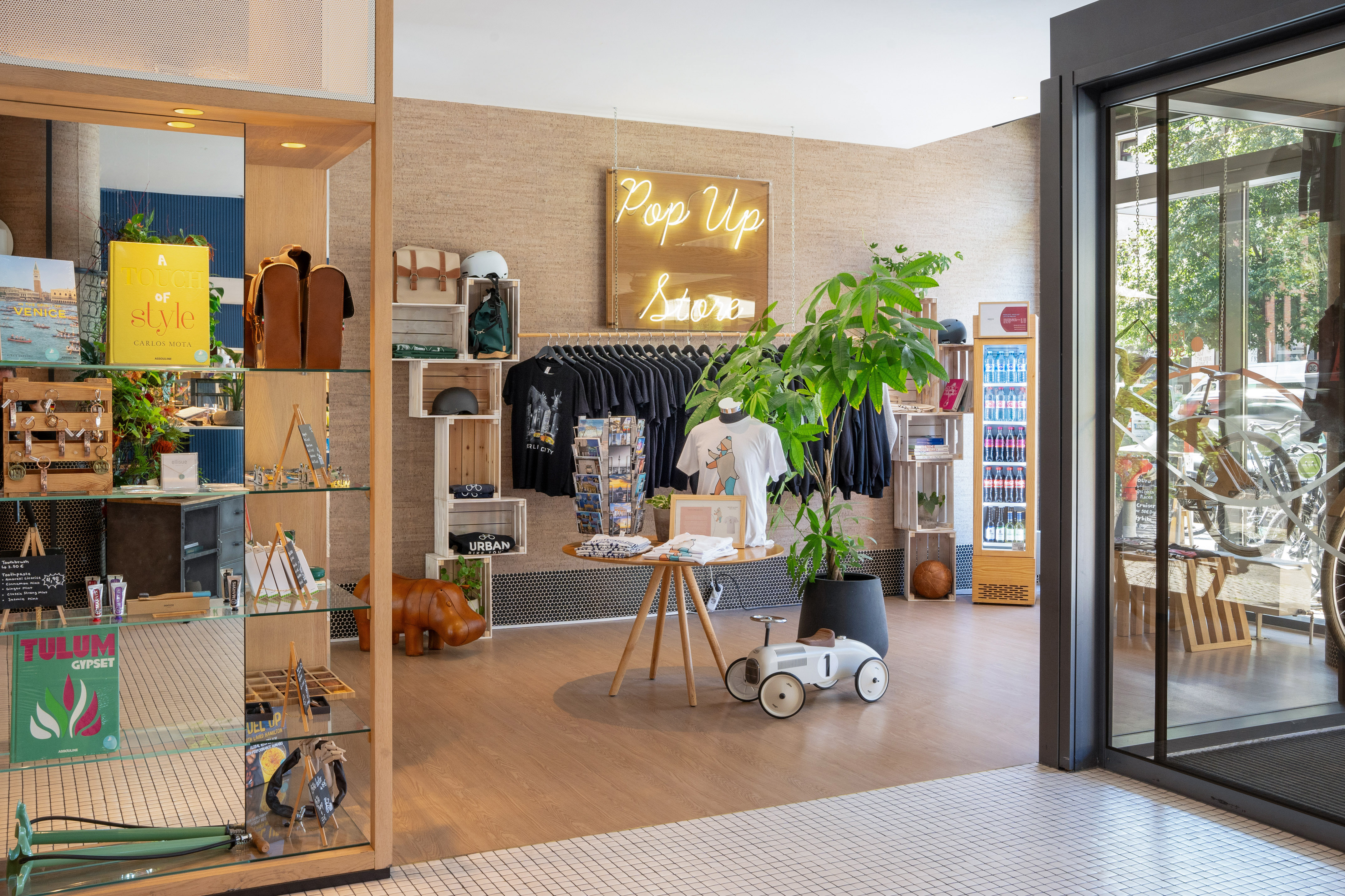 a store with a display of clothes and a sign
