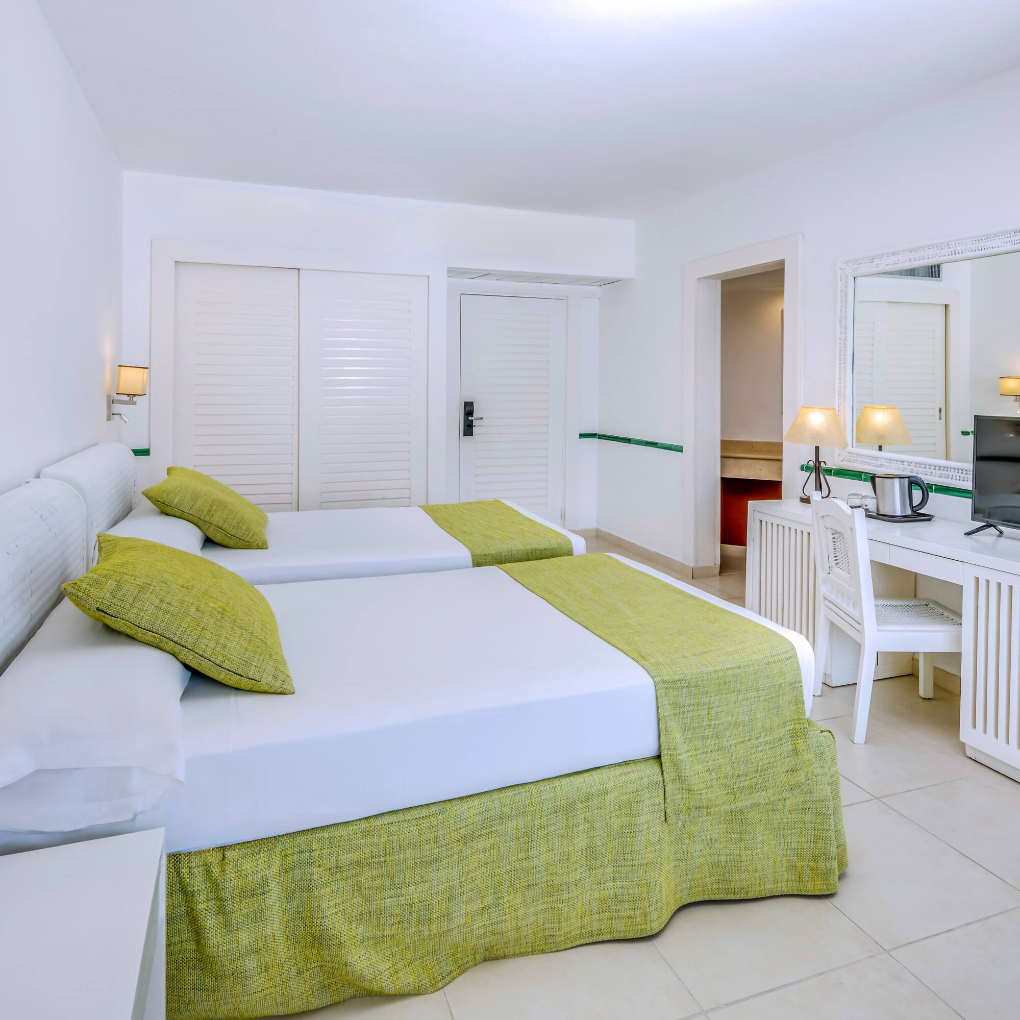 a room with two beds and a desk