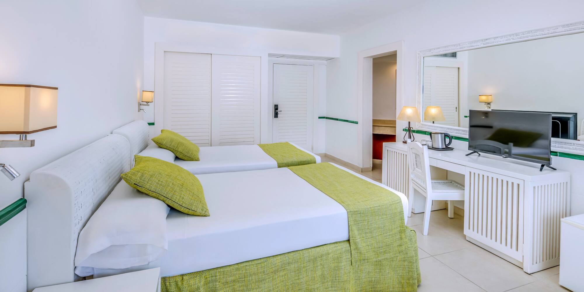 a room with two beds and a desk