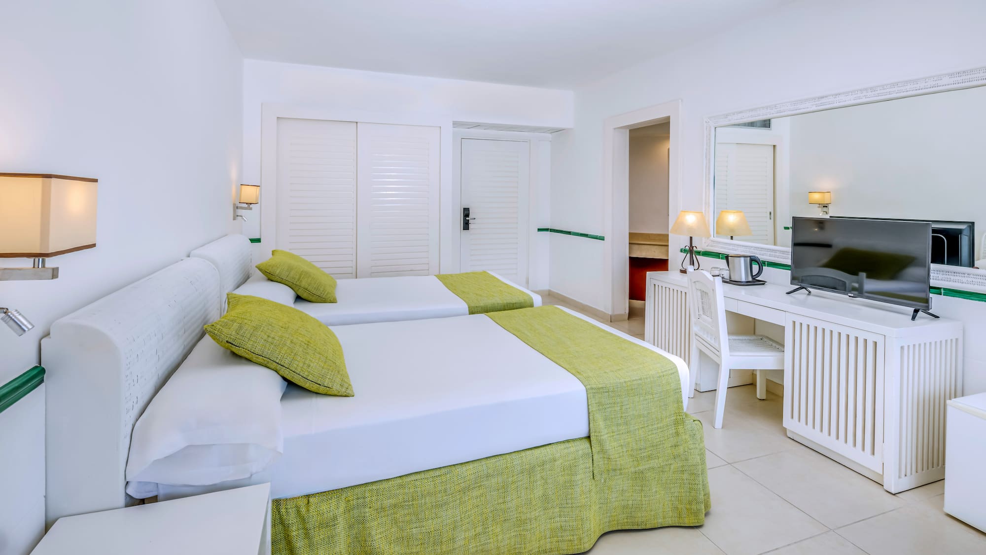 a room with two beds and a desk