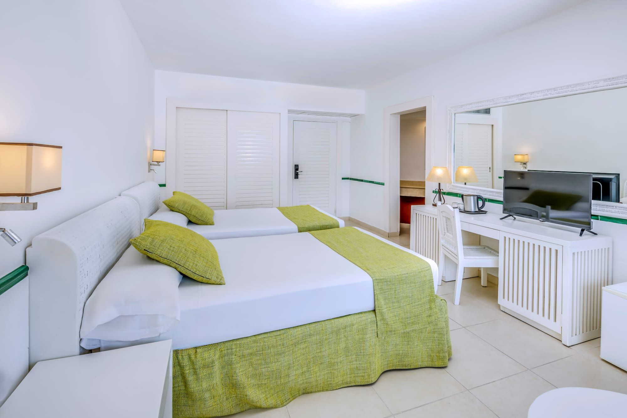 a room with two beds and a desk