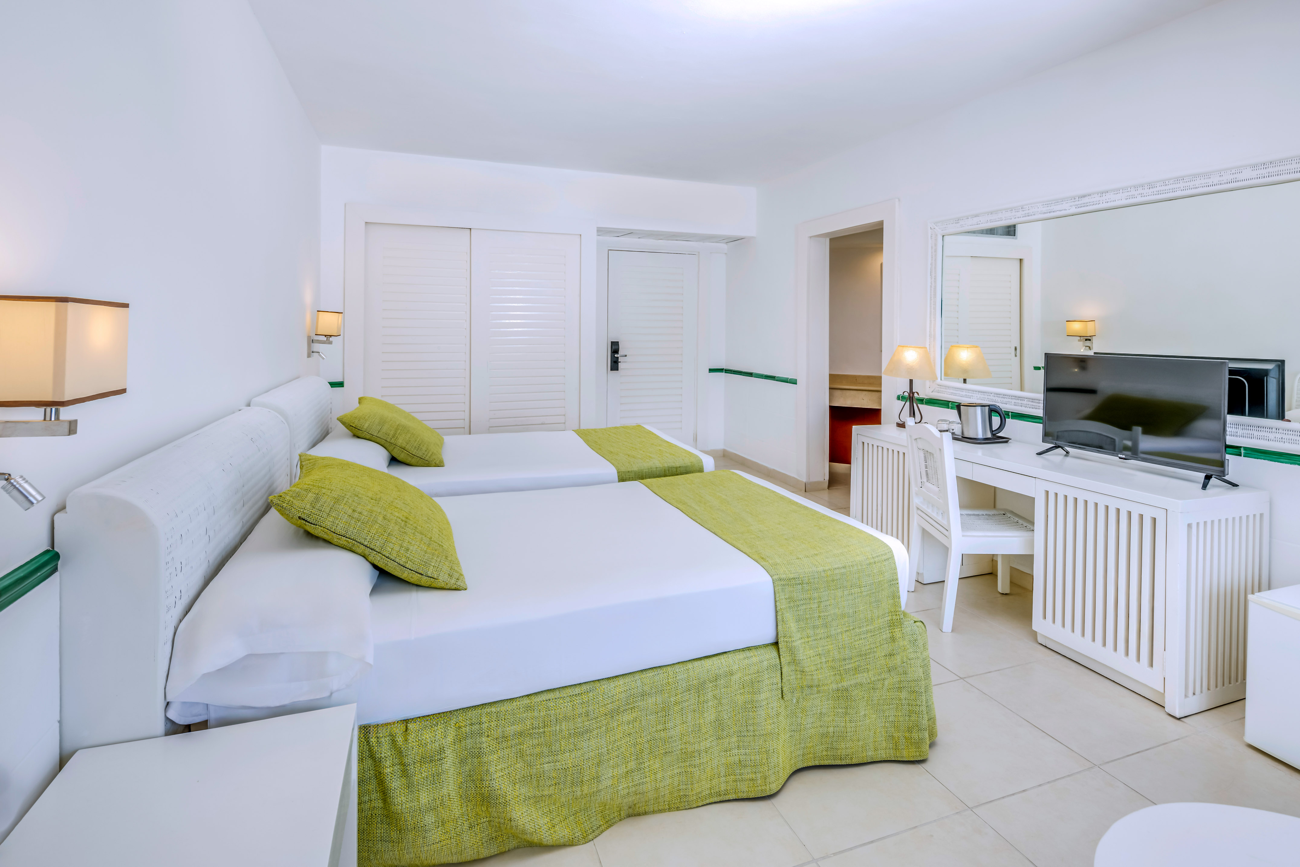 a room with two beds and a desk