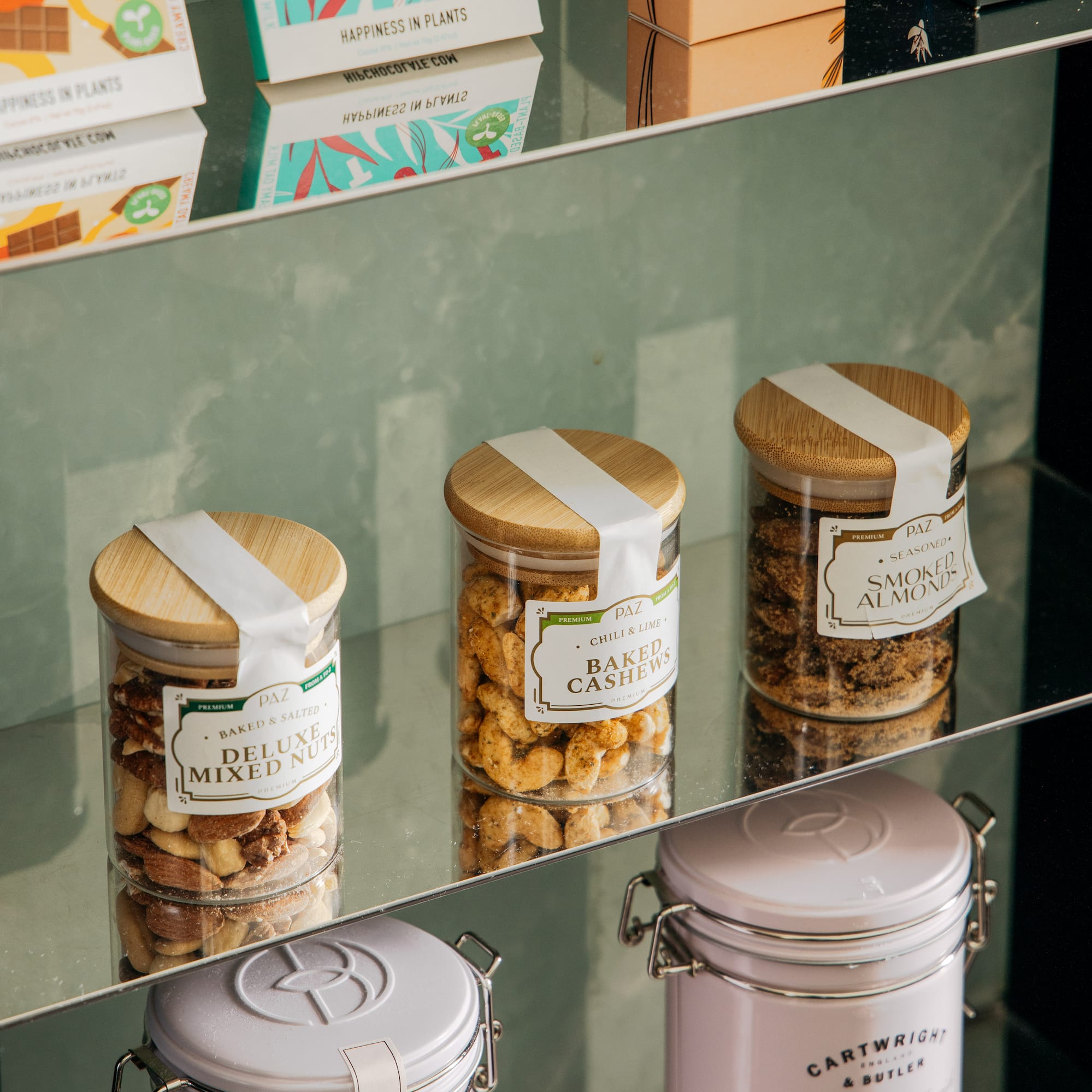 a glass shelf with jars of food