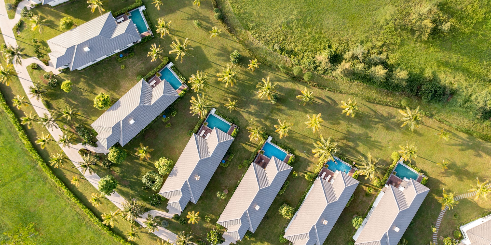 a group of houses with pools in a circle