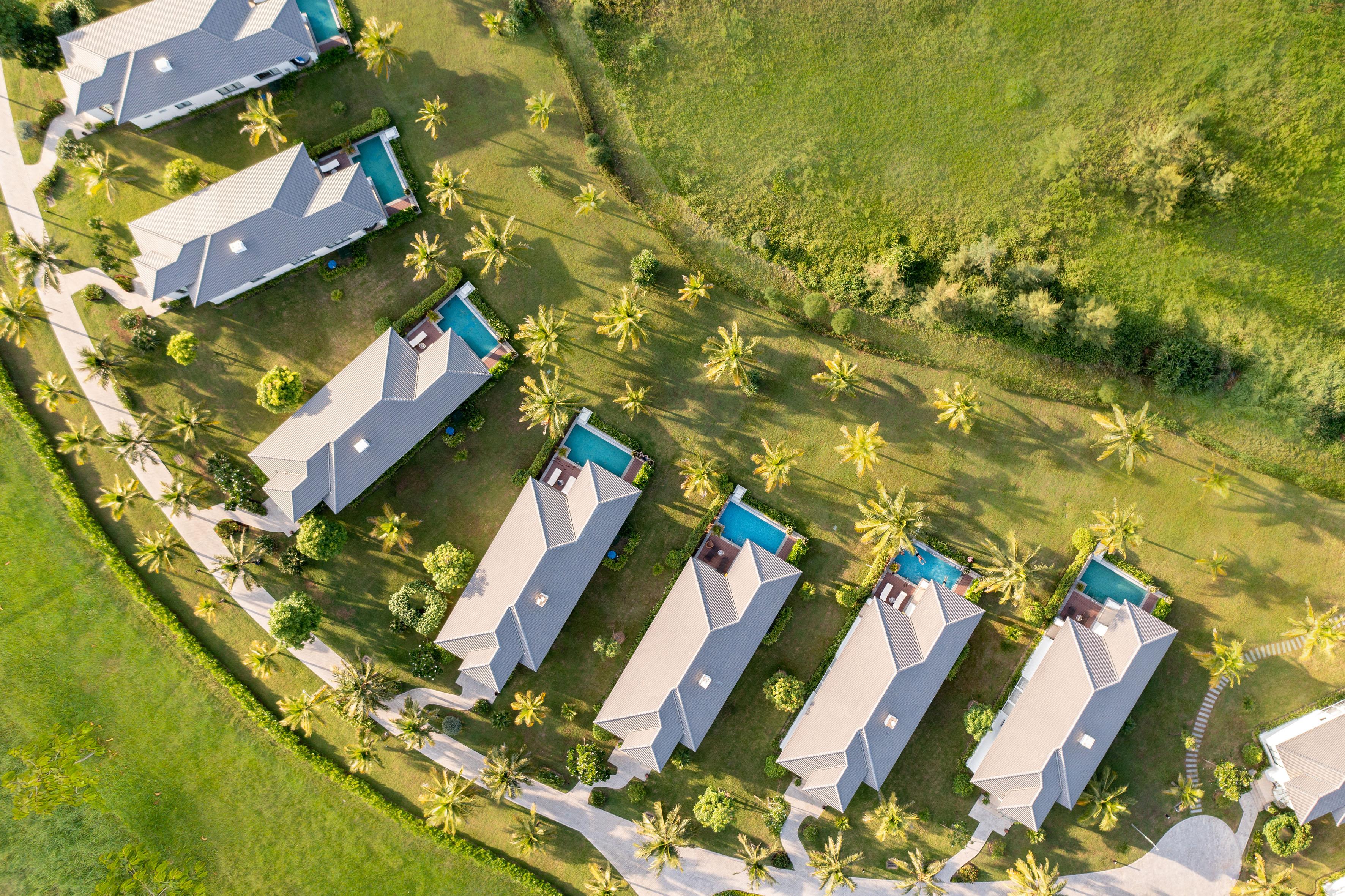 a group of houses with pools in a circle