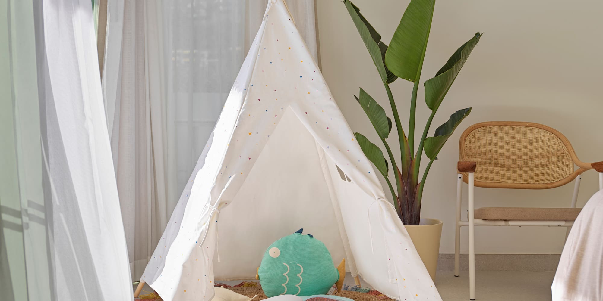 a teepee with a book and a plant in the background