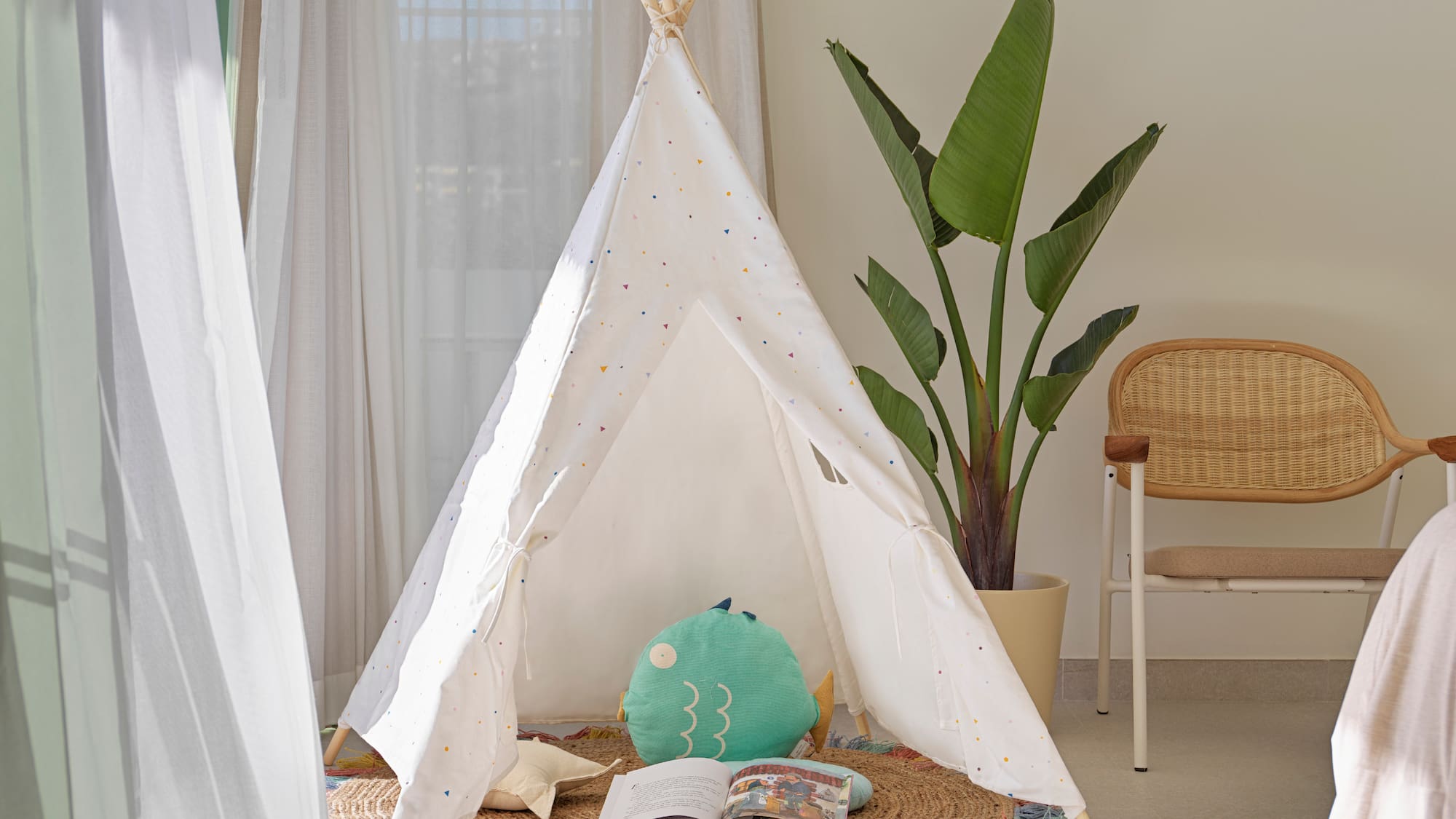 a teepee with a book and a plant in the background