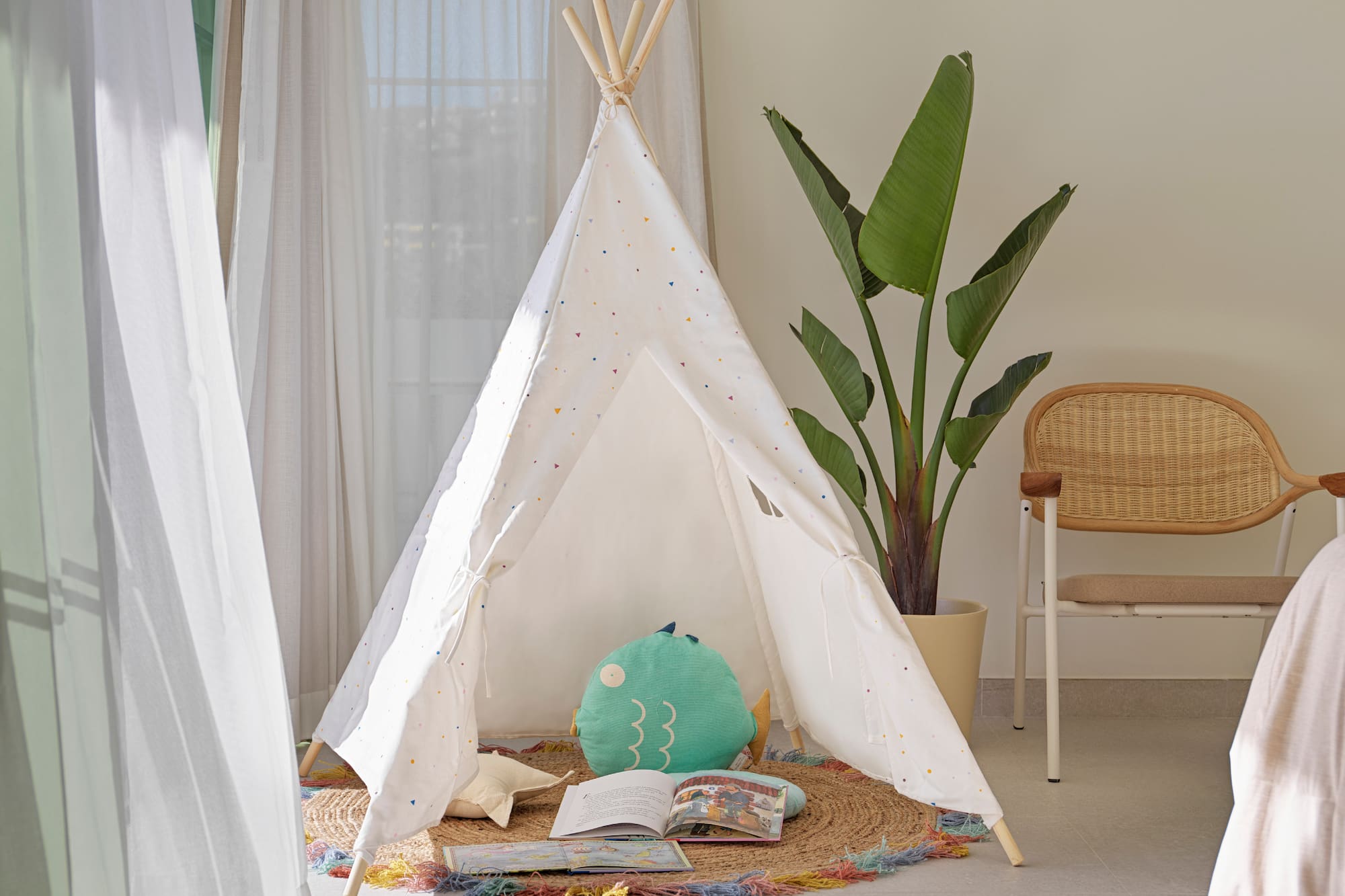 a teepee with a book and a plant in the background