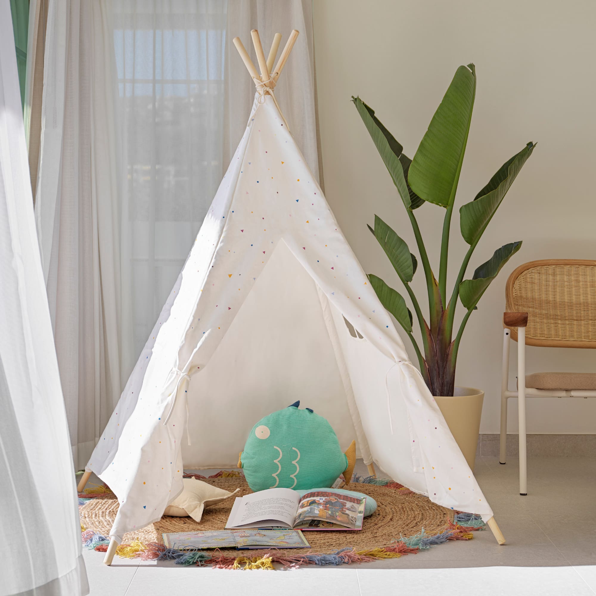 a teepee with a book and a plant in the background
