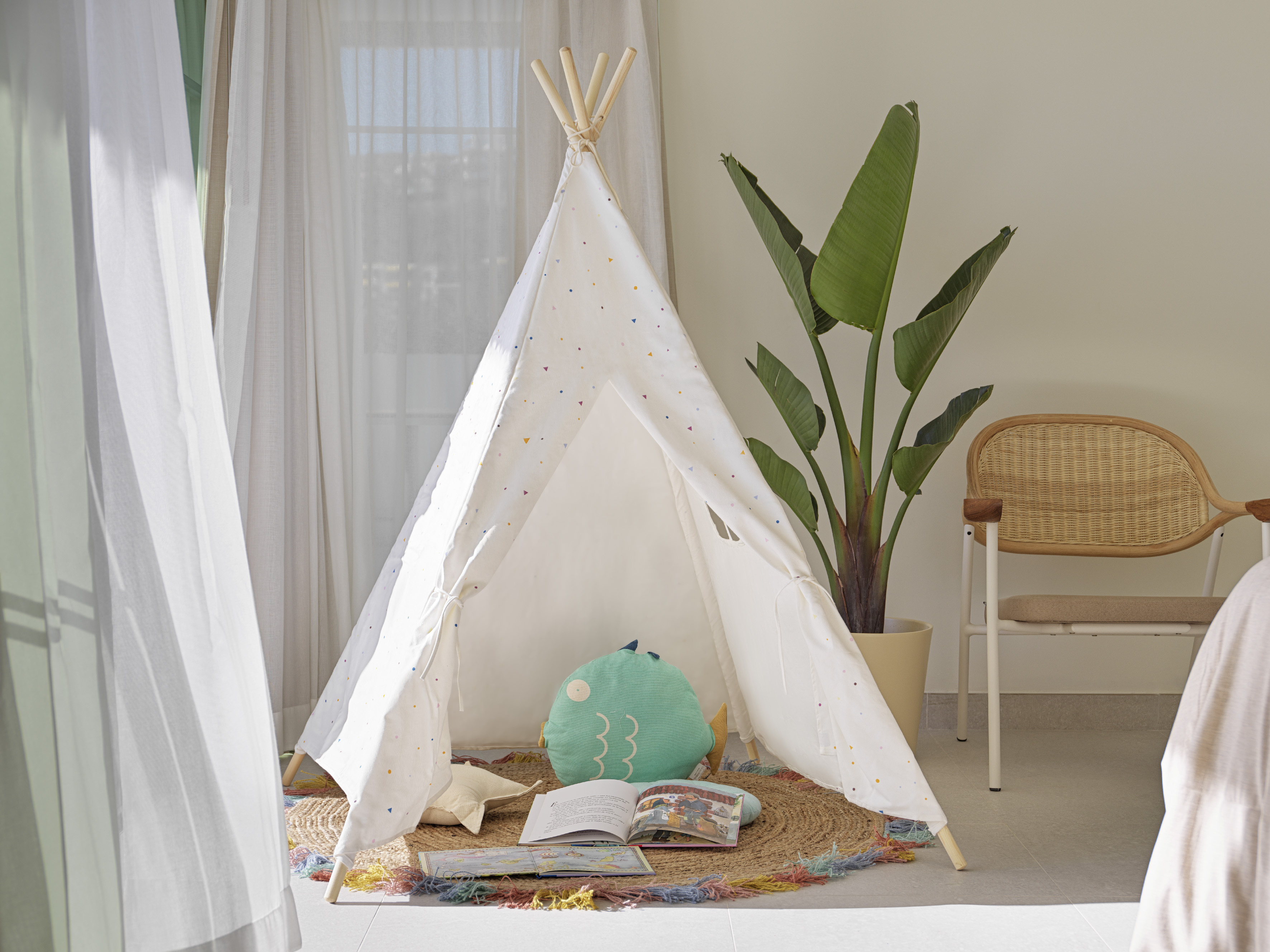 a teepee with a book and a plant in the background
