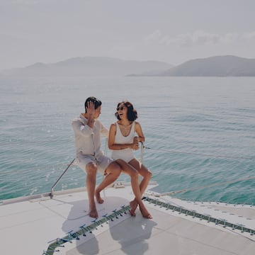 a man and woman sitting on a boat