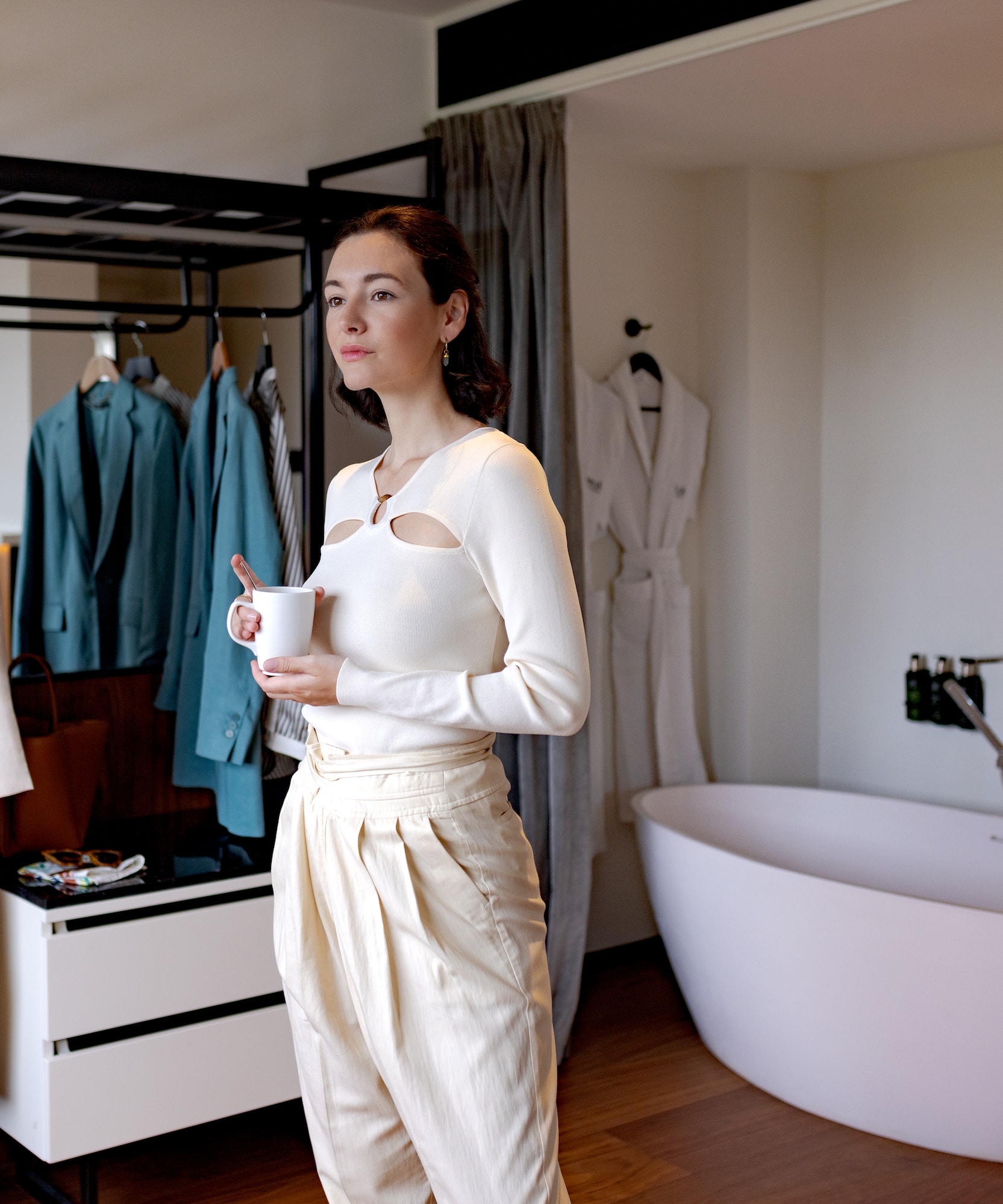a woman holding a cup in a room