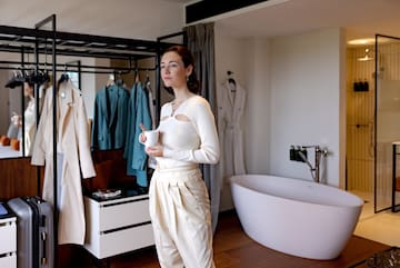 a woman holding a cup in a room