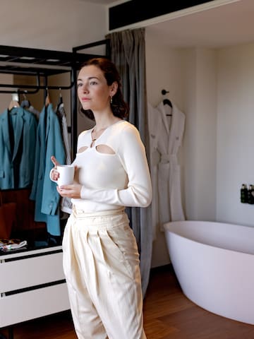 a woman holding a cup in a room