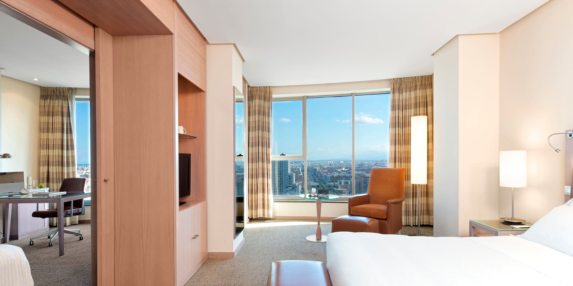 a room with a large window and a bed