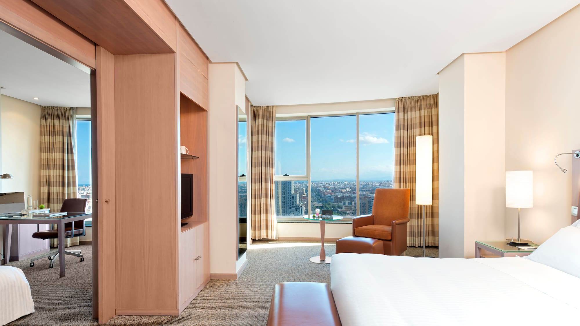 a room with a large window and a bed