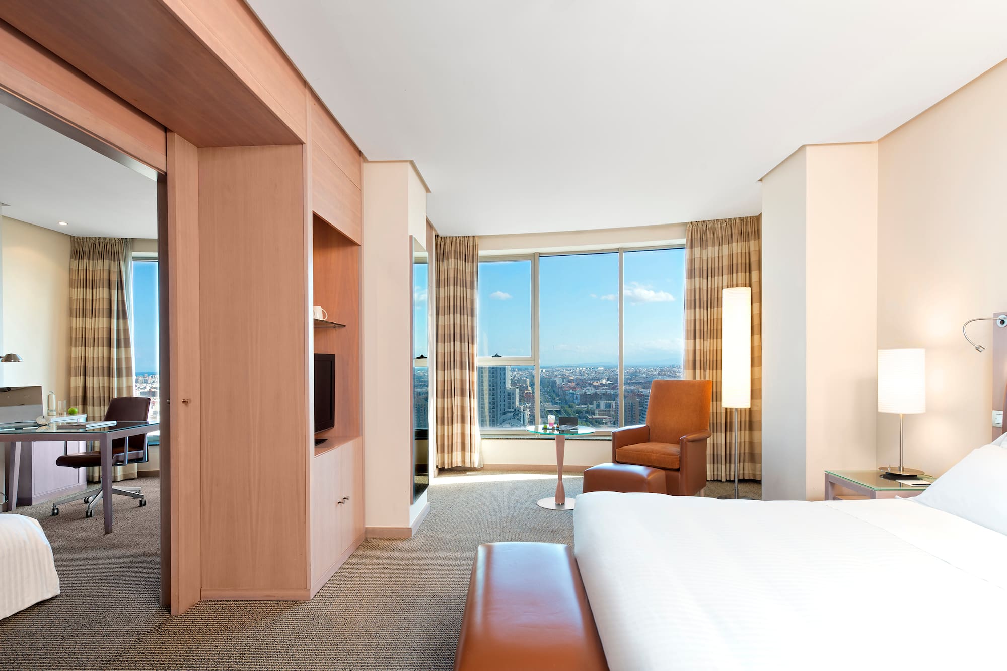 a room with a large window and a bed