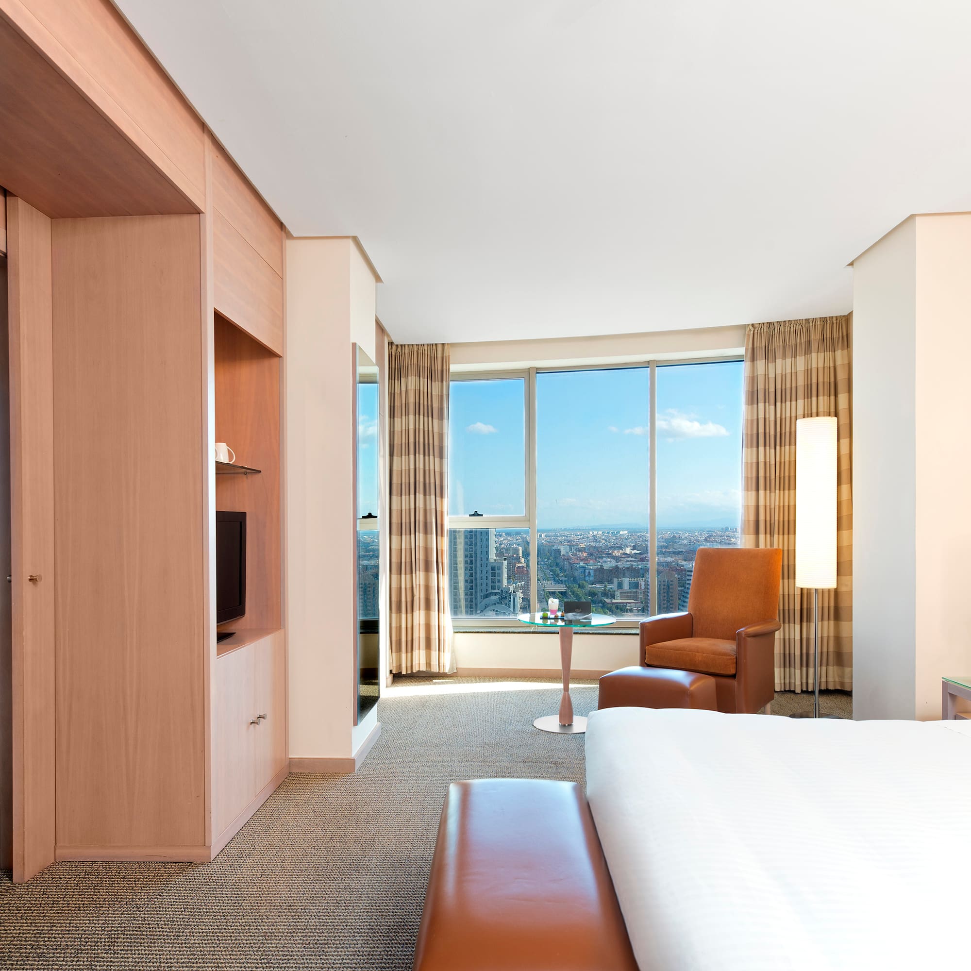 a room with a large window and a bed