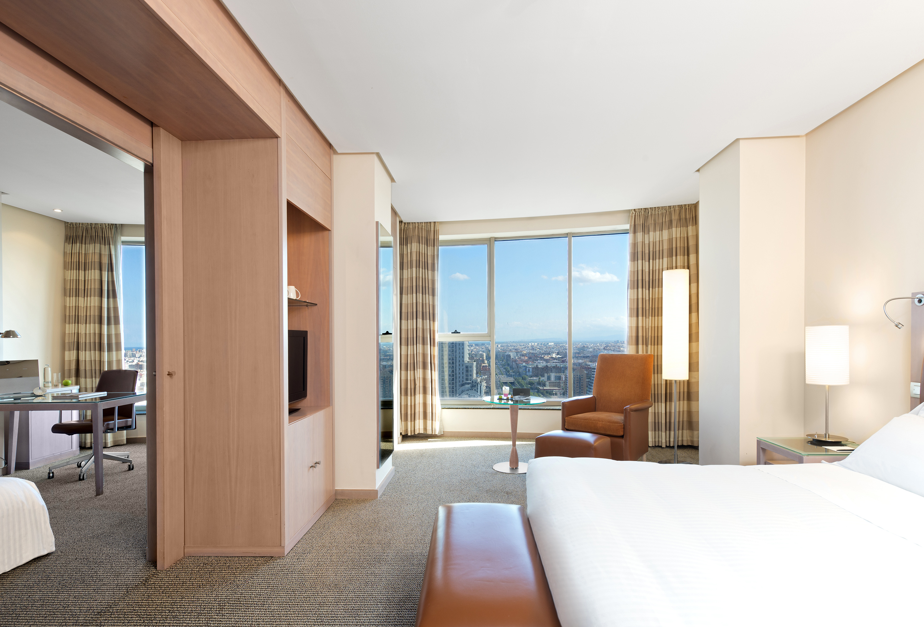 a room with a large window and a bed