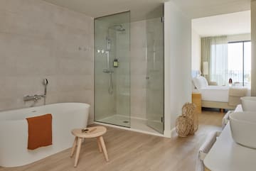 a bathroom with a glass shower and a bathtub