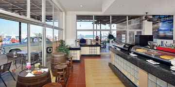 a room with a buffet and a large window