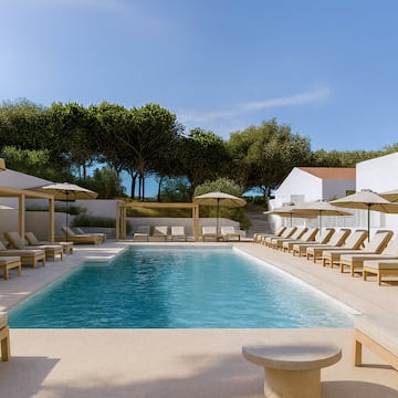 a pool with lounge chairs and umbrellas