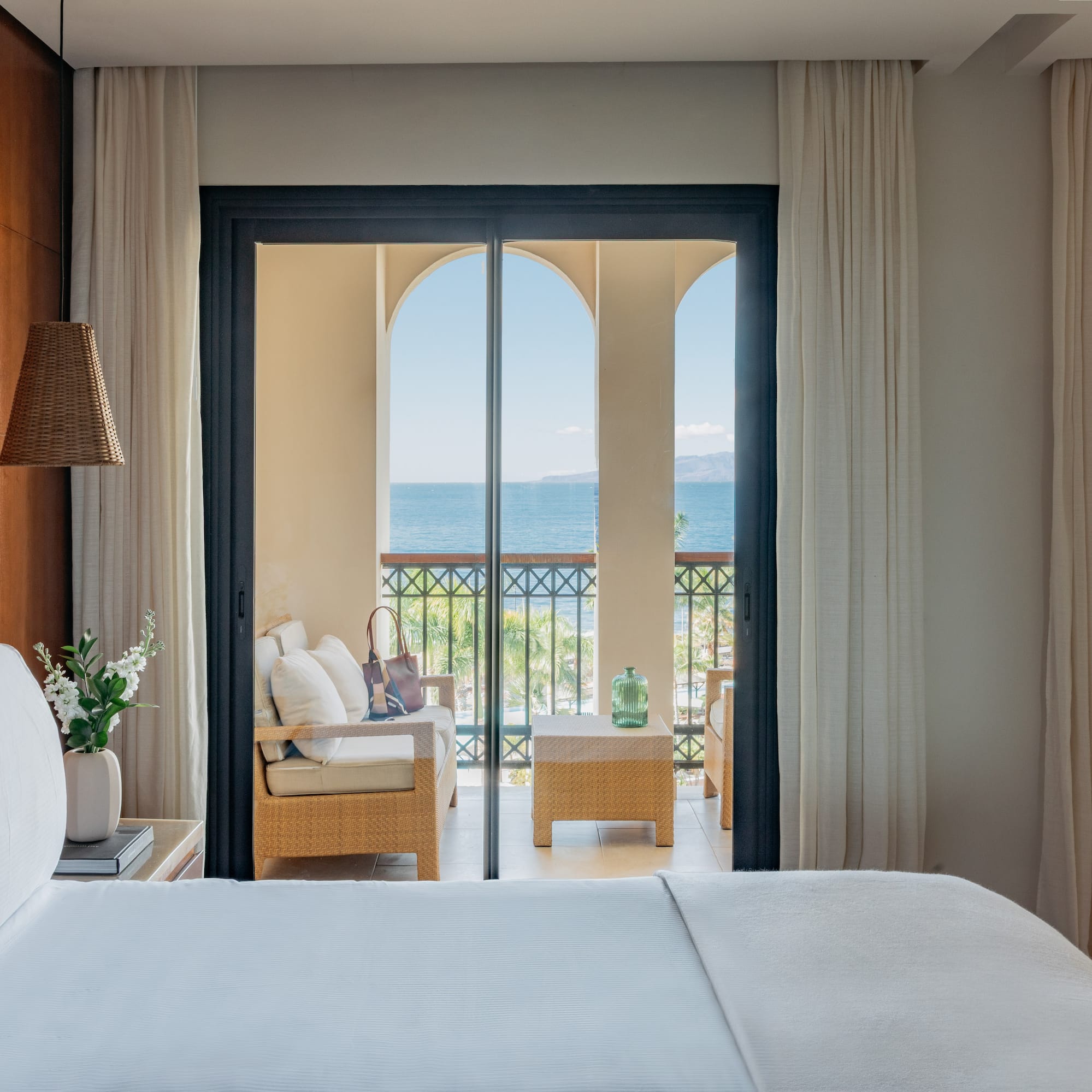 a room with a bed and a chair and a table