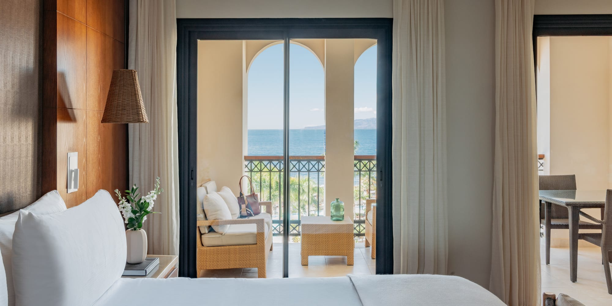 a room with a bed and a chair and a table