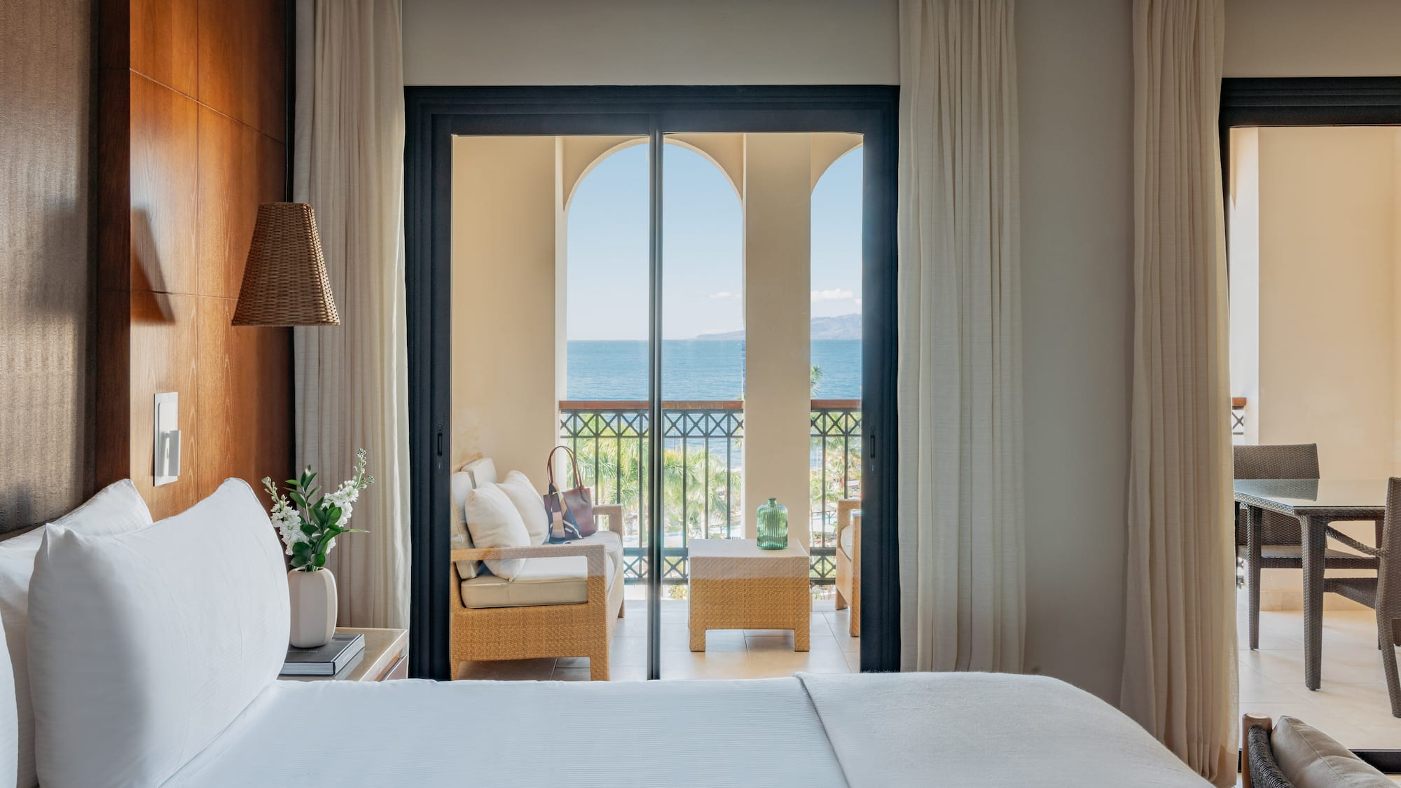 a room with a bed and a chair and a table