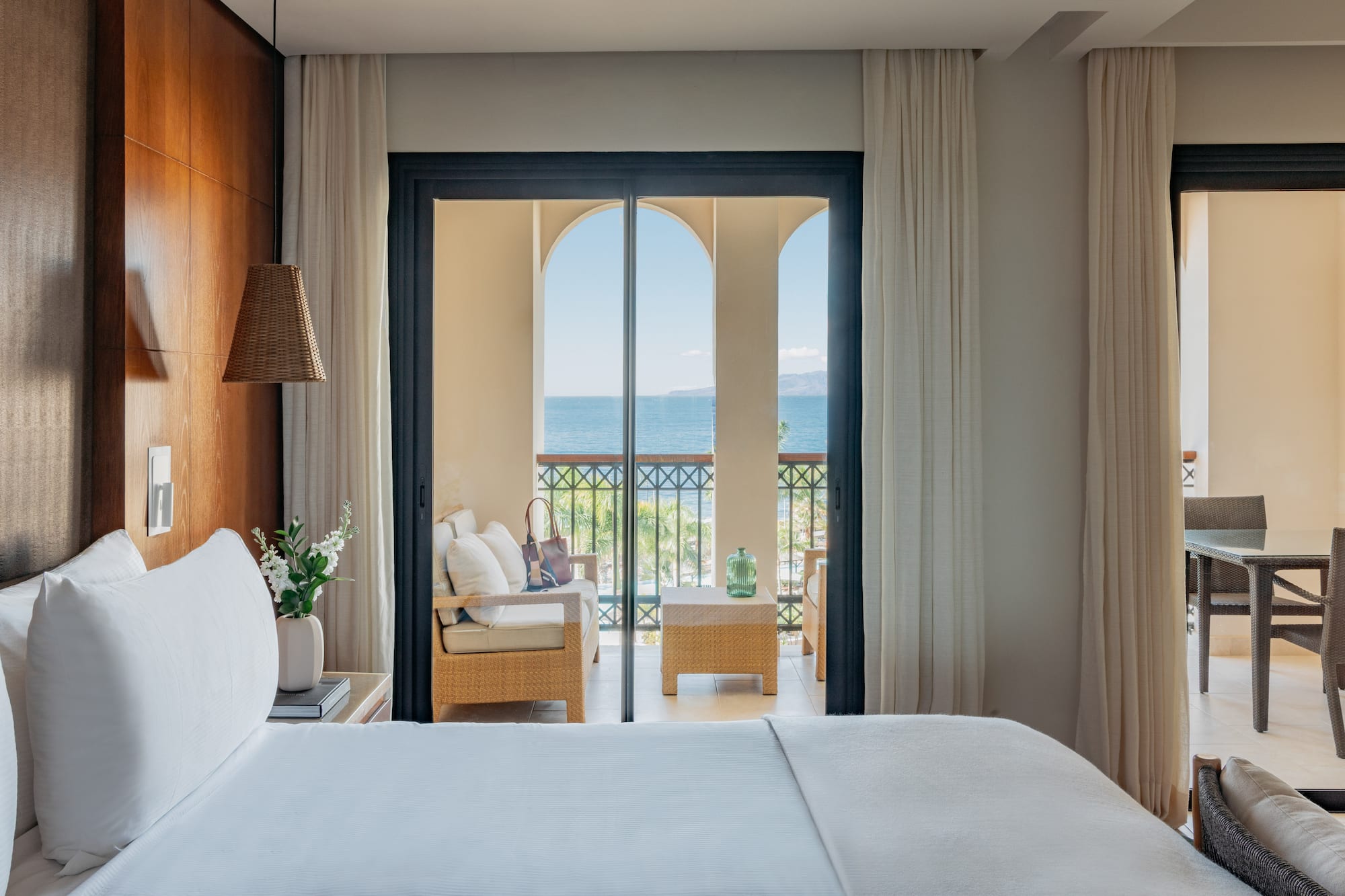 a room with a bed and a chair and a table