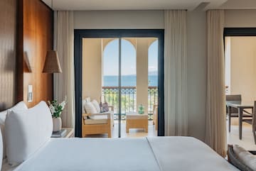 a room with a bed and a chair and a table