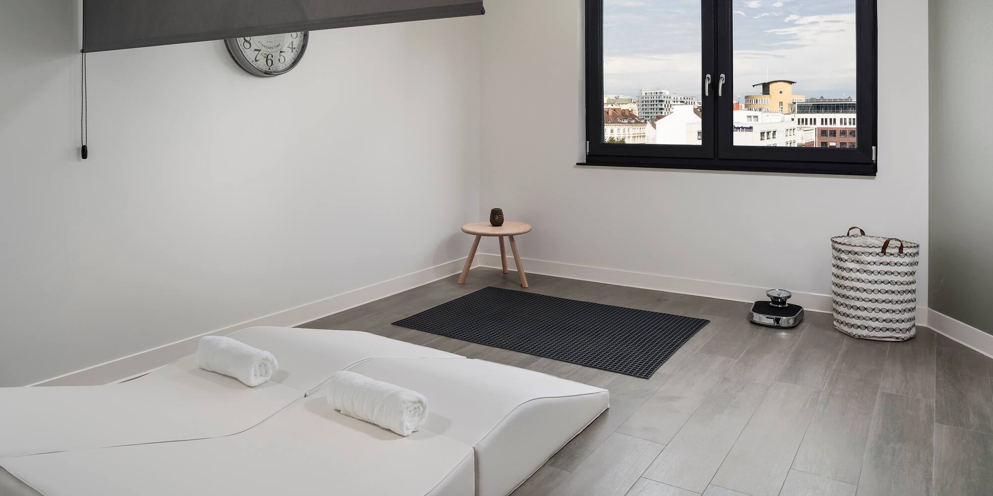 a room with a bed and a clock