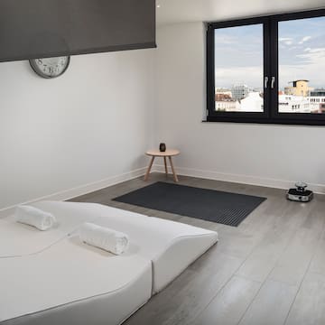 a room with a bed and a clock