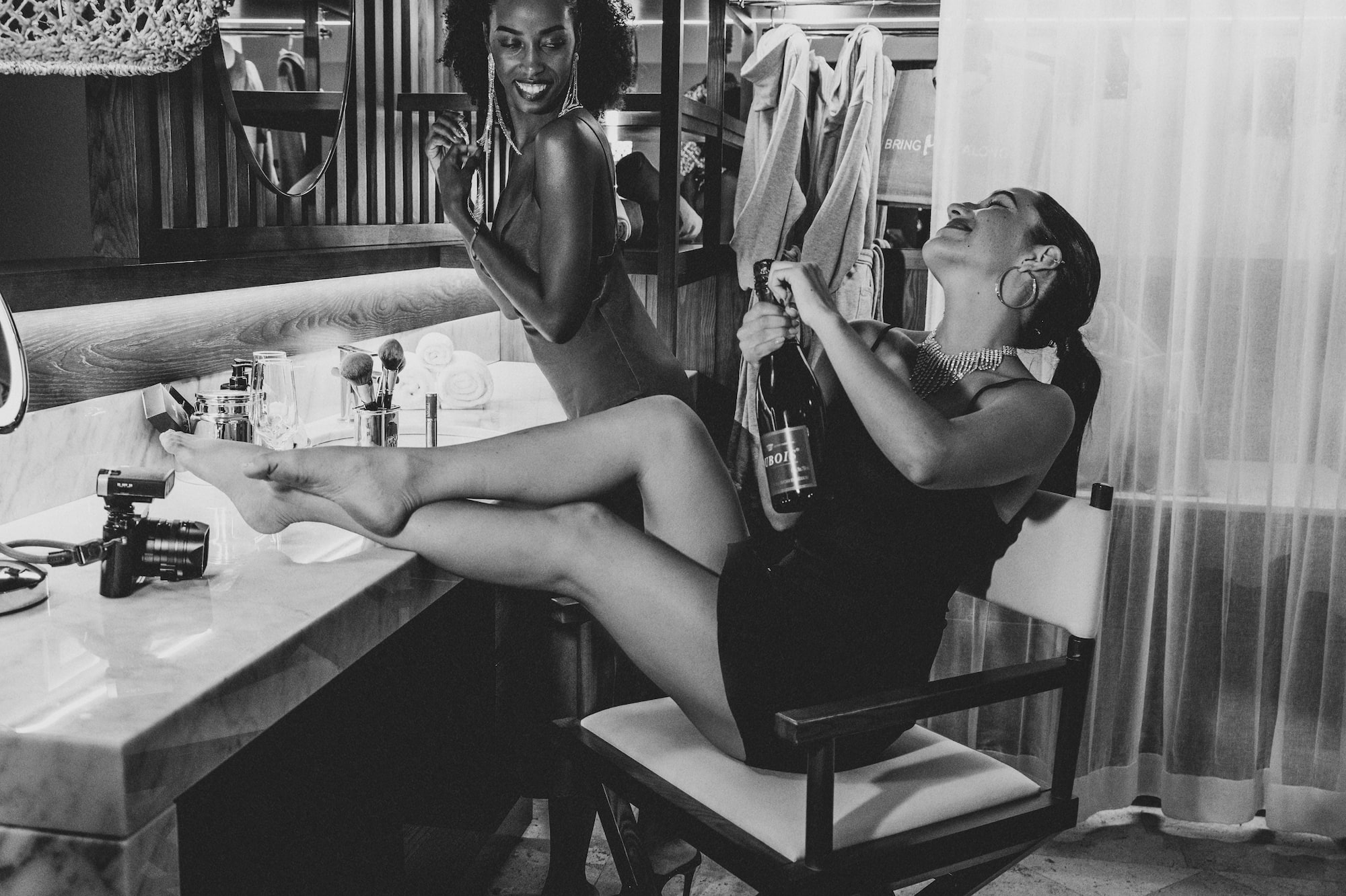 two women sitting on a chair