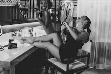 two women sitting on a chair