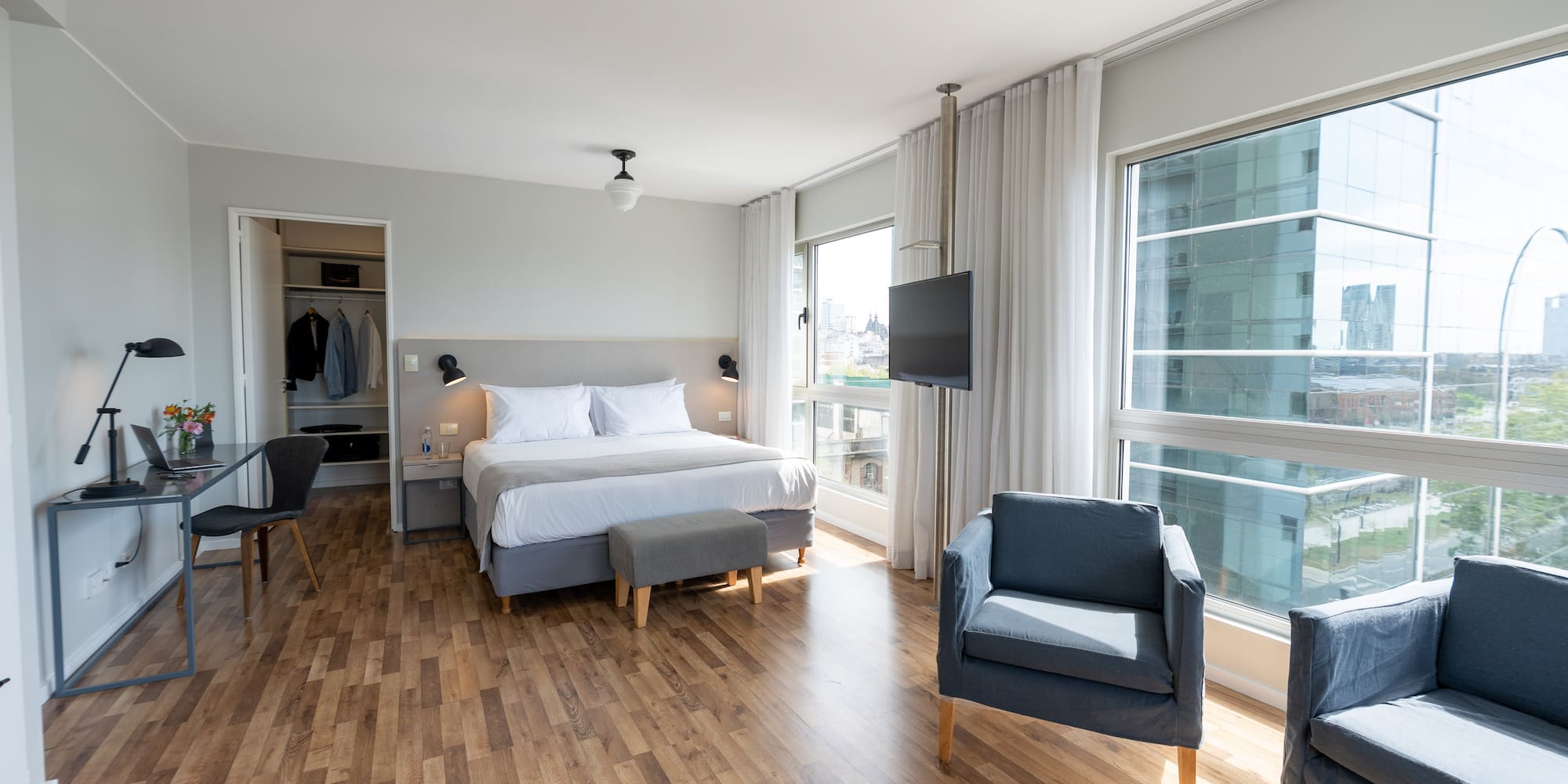 a bedroom with a bed and chairs