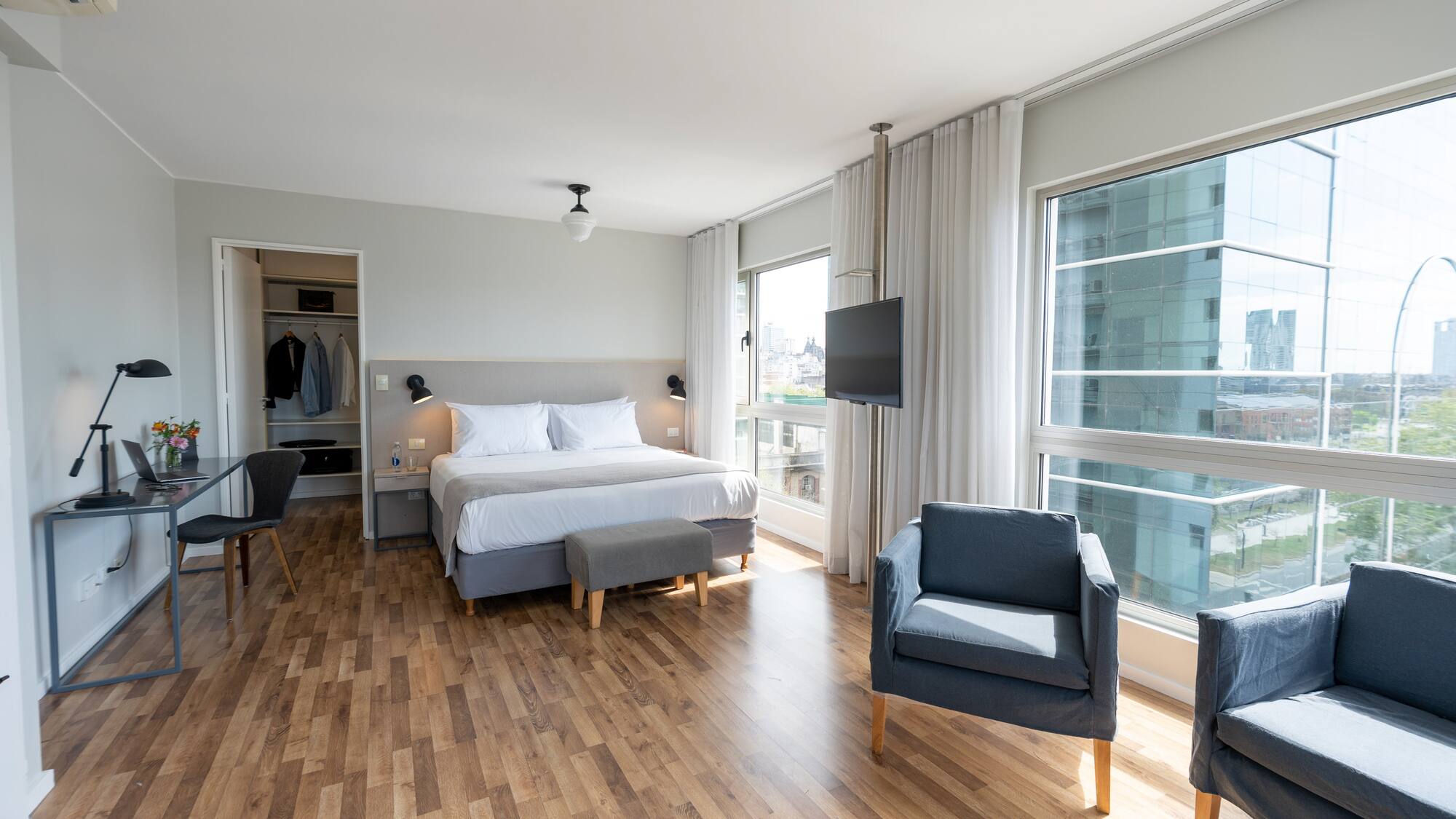 a bedroom with a bed and chairs