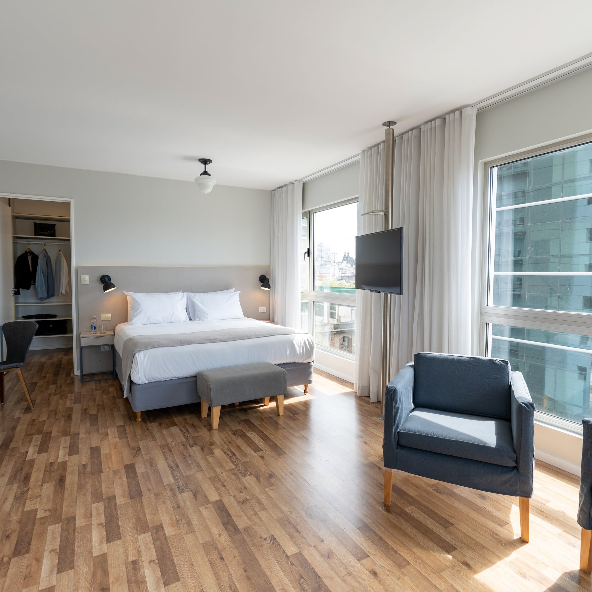 a bedroom with a bed and chairs