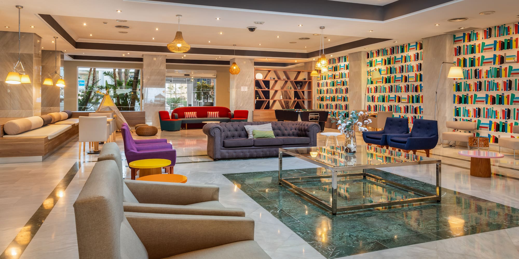 a room with a glass fountain and couches