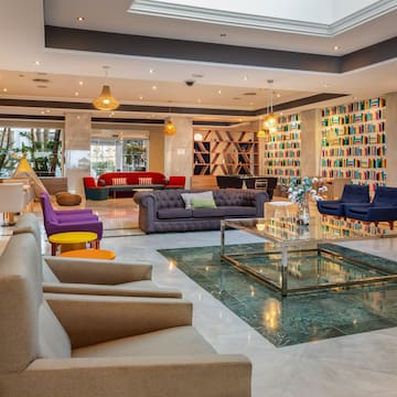 a room with a glass fountain and couches