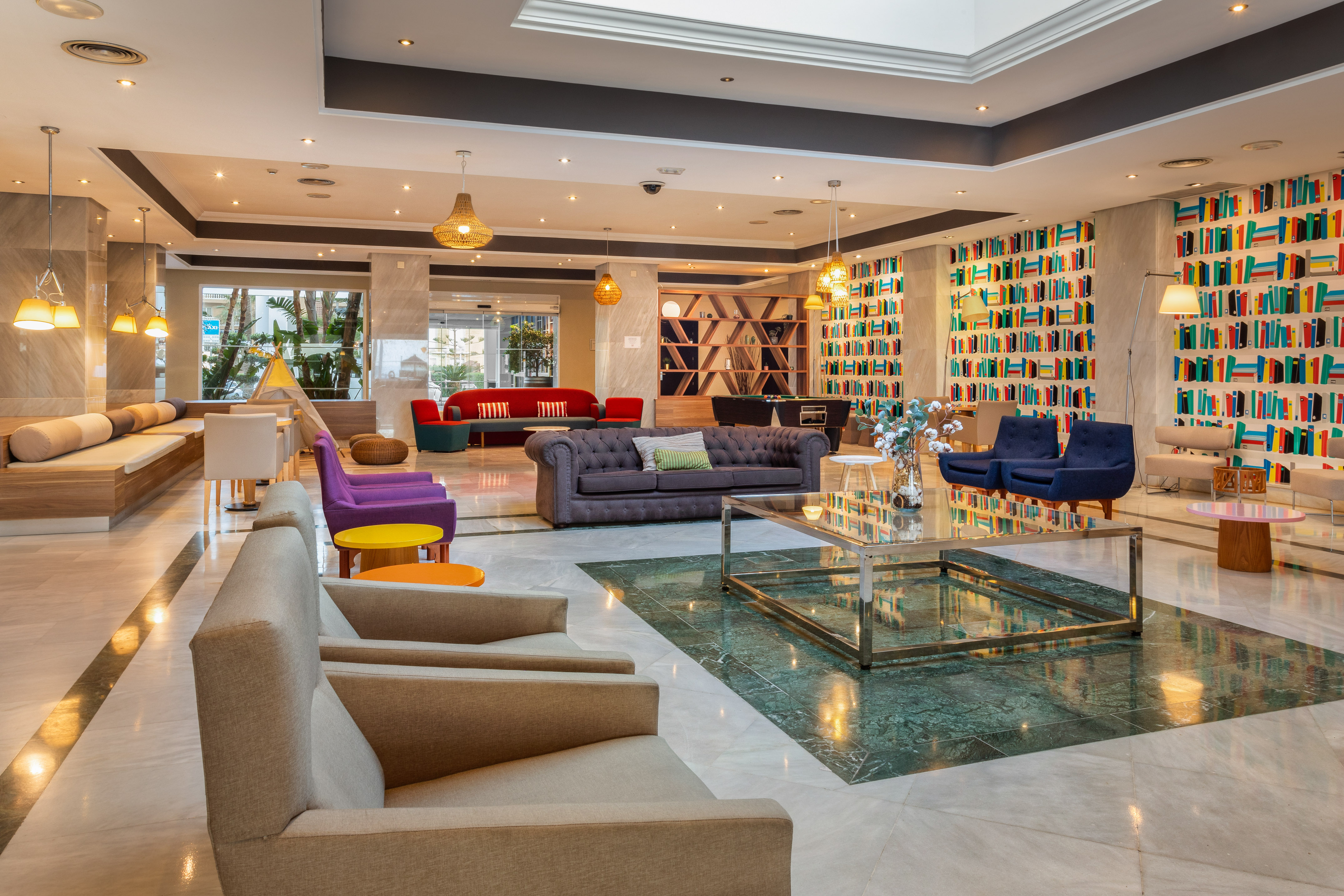 a room with a glass fountain and couches