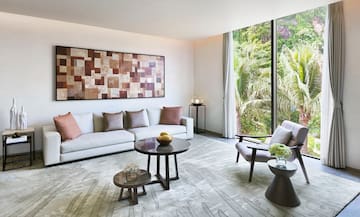 a living room with a couch and chairs