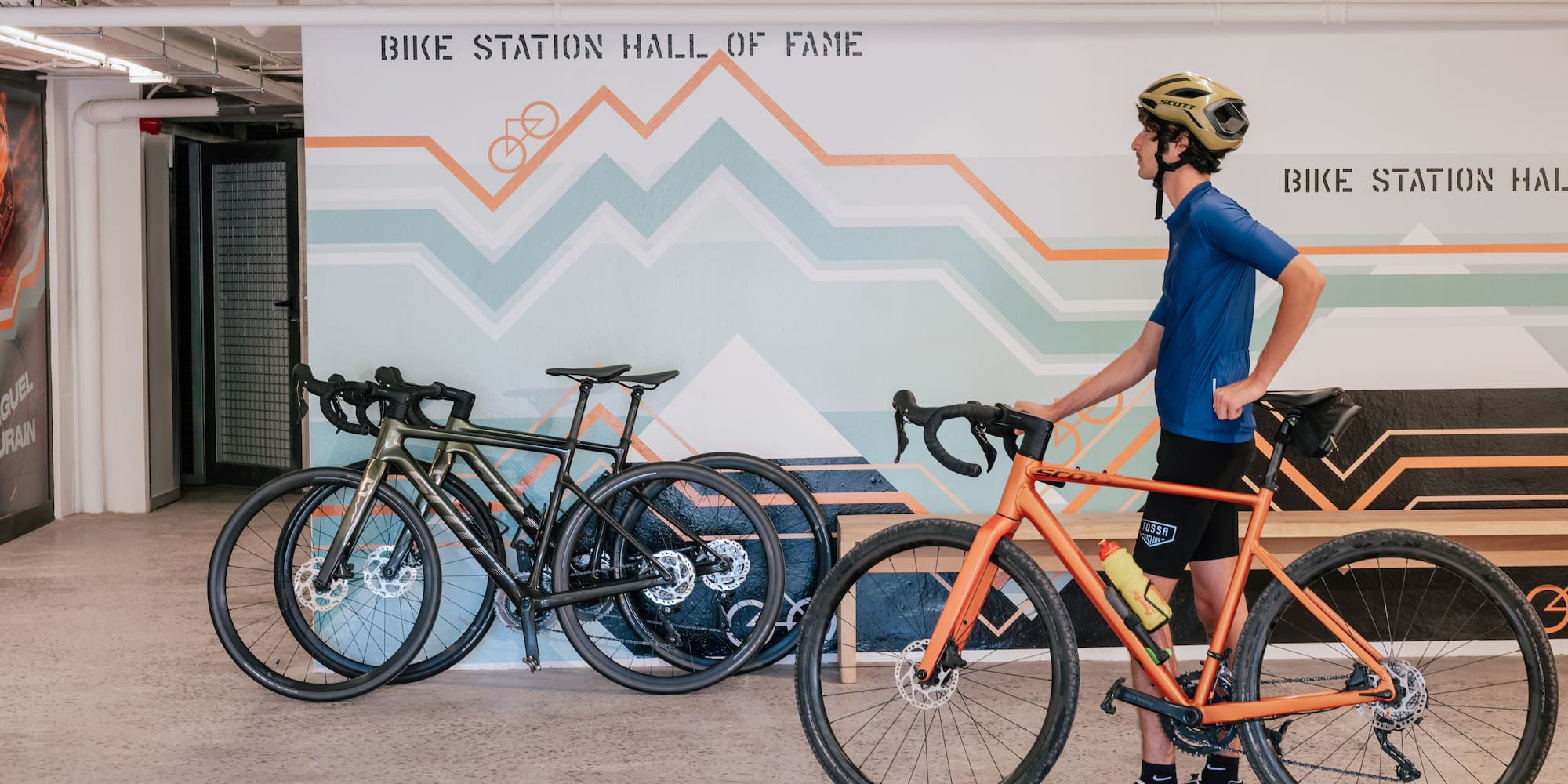 a man with a helmet and a bicycle