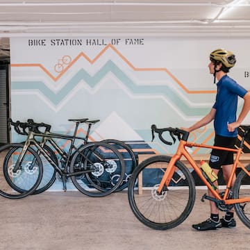 a man with a helmet and a bicycle