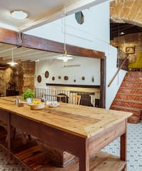 a table in a room with stairs and a staircase