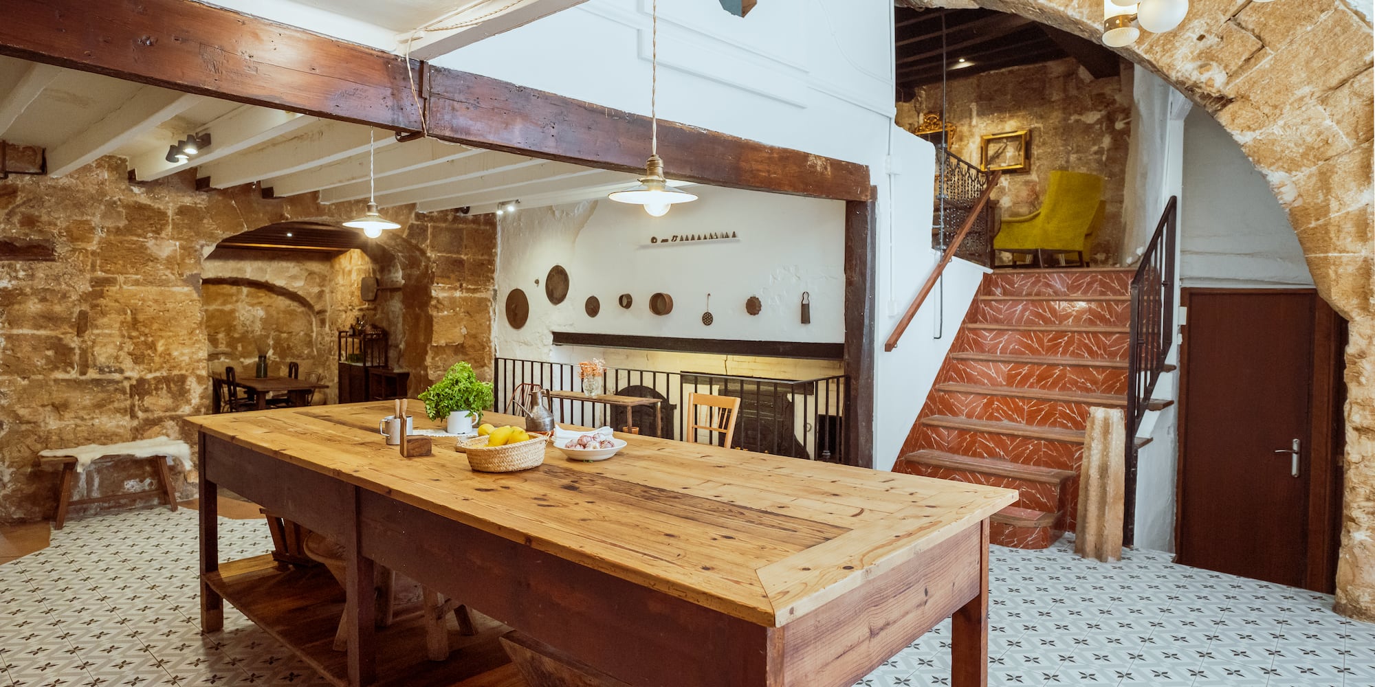 a table in a room with stairs and a staircase