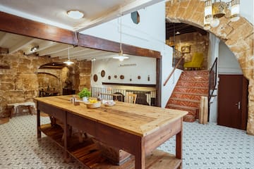 a table in a room with stairs and a staircase