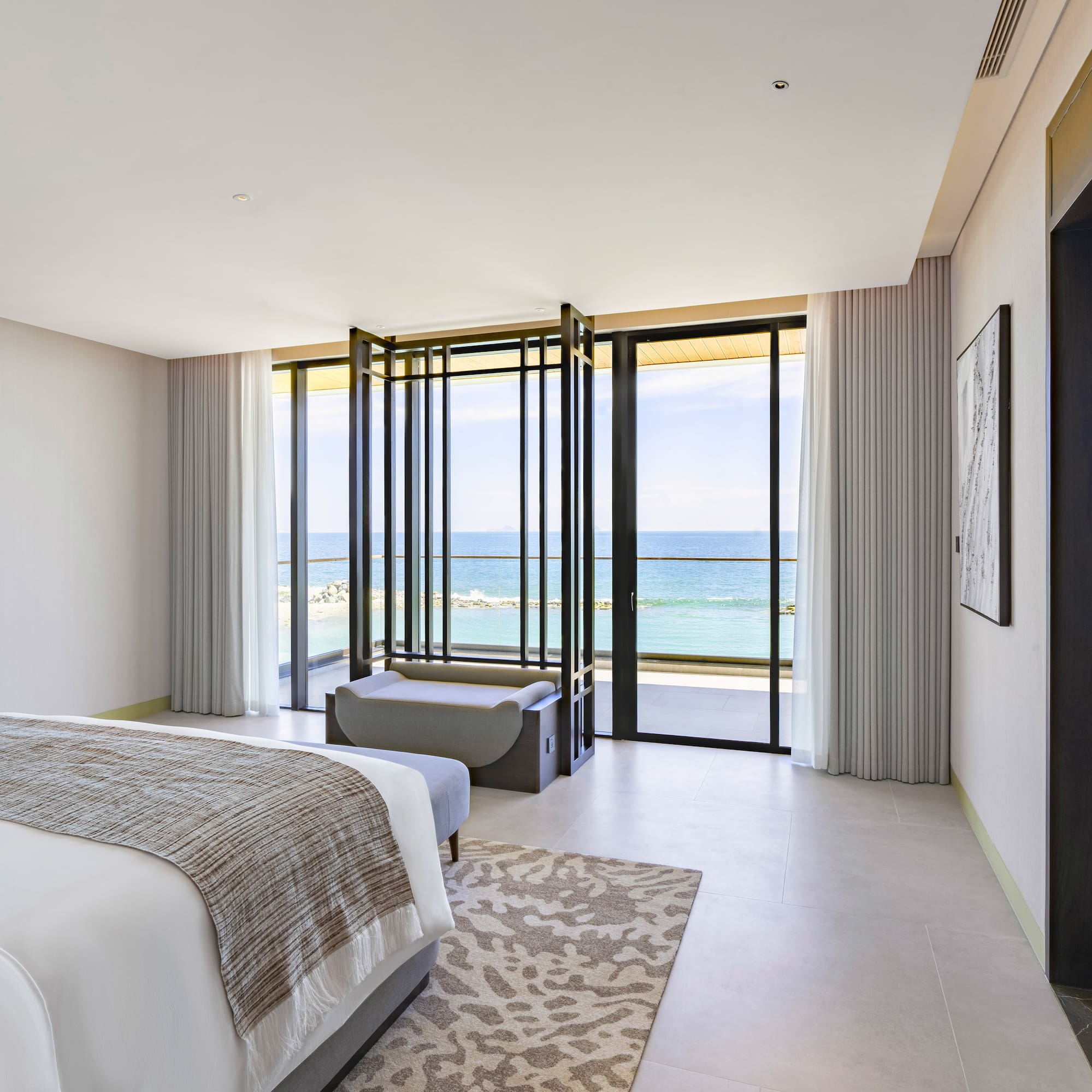 a bedroom with a view of the ocean