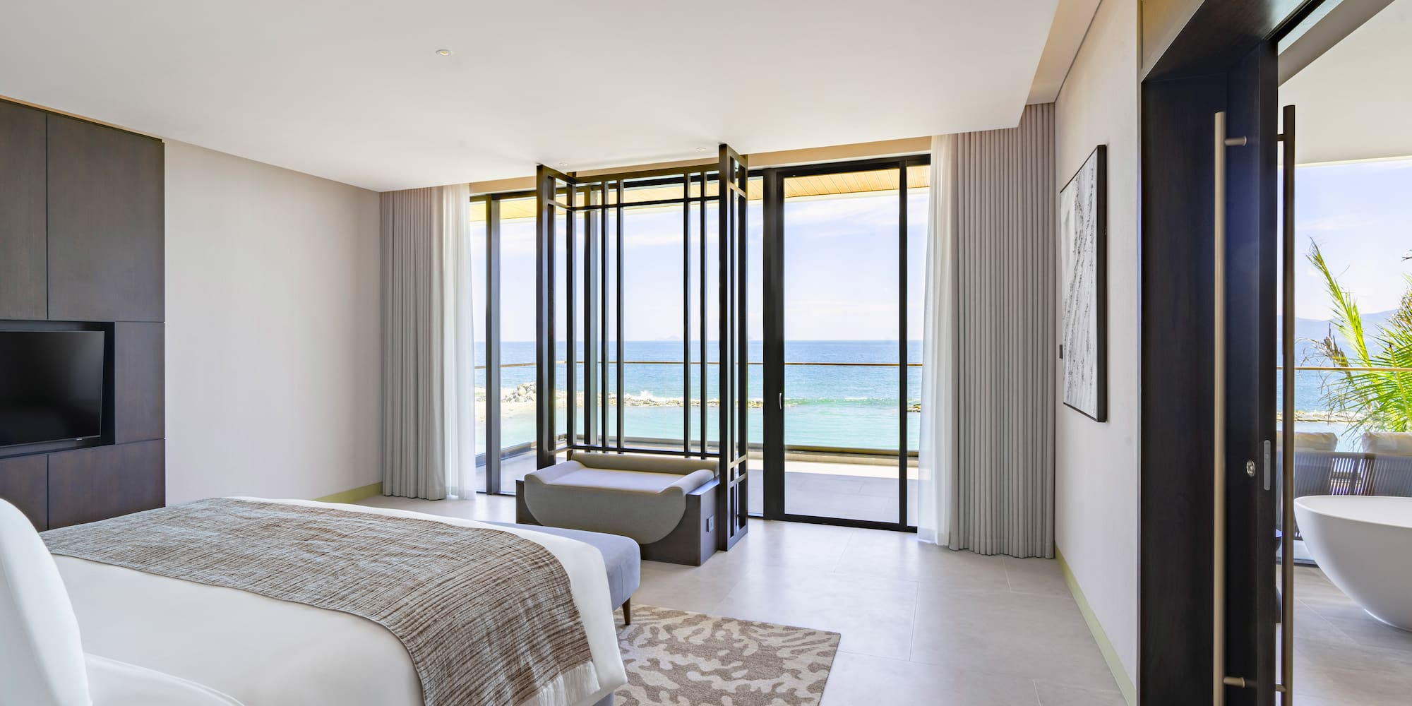 a bedroom with a view of the ocean