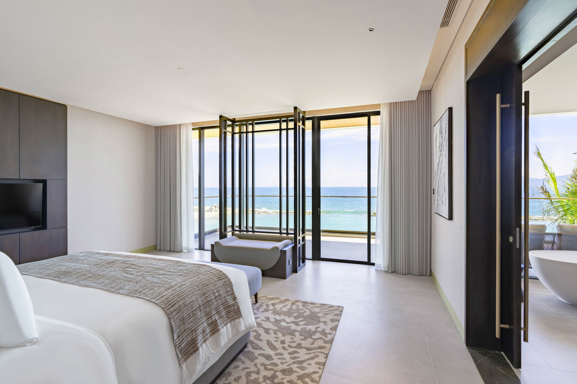 a bedroom with a view of the ocean